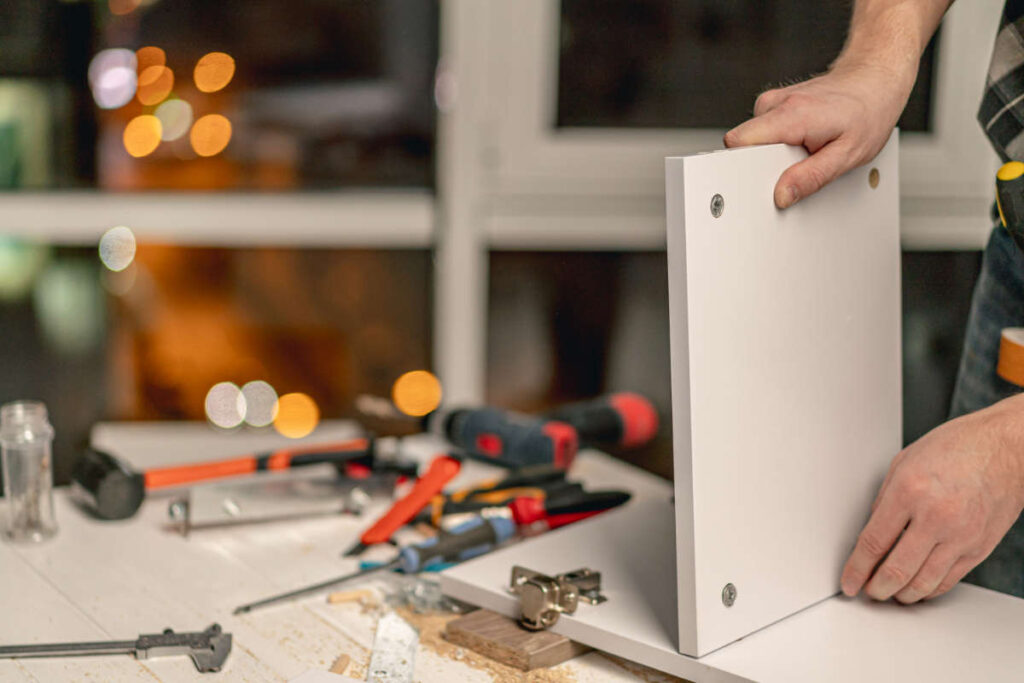 Person putting together a structure utilizing EcoSynthetix materials