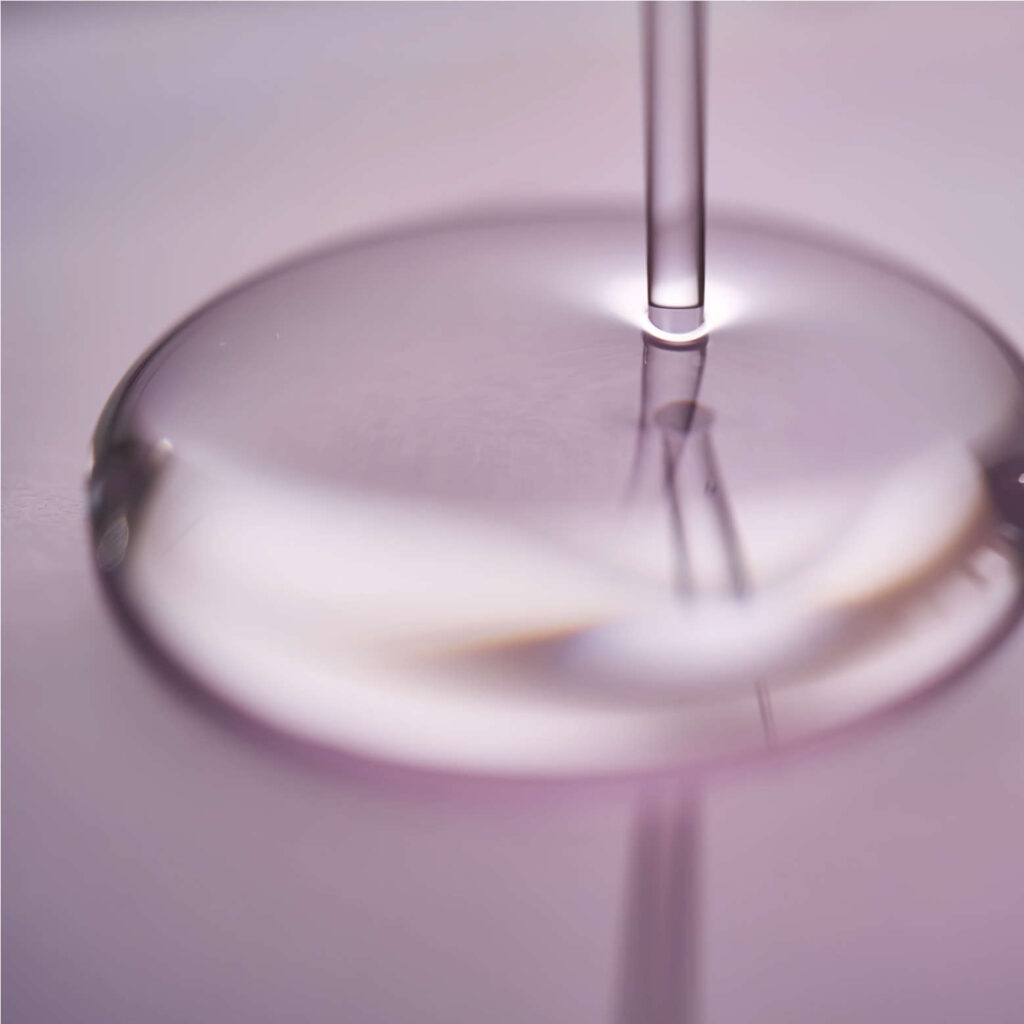 A drop of gel on a purple background.